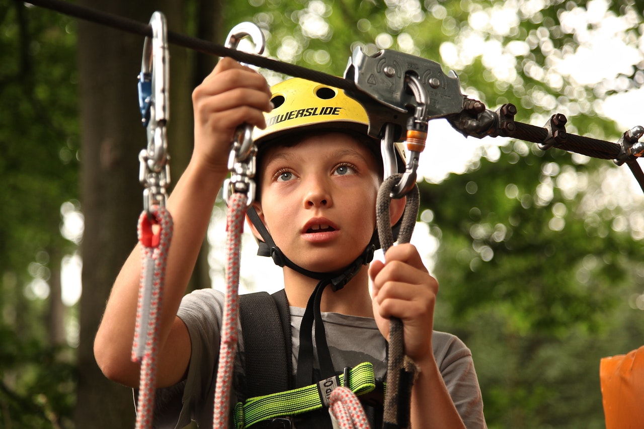 young person connecting to zip line