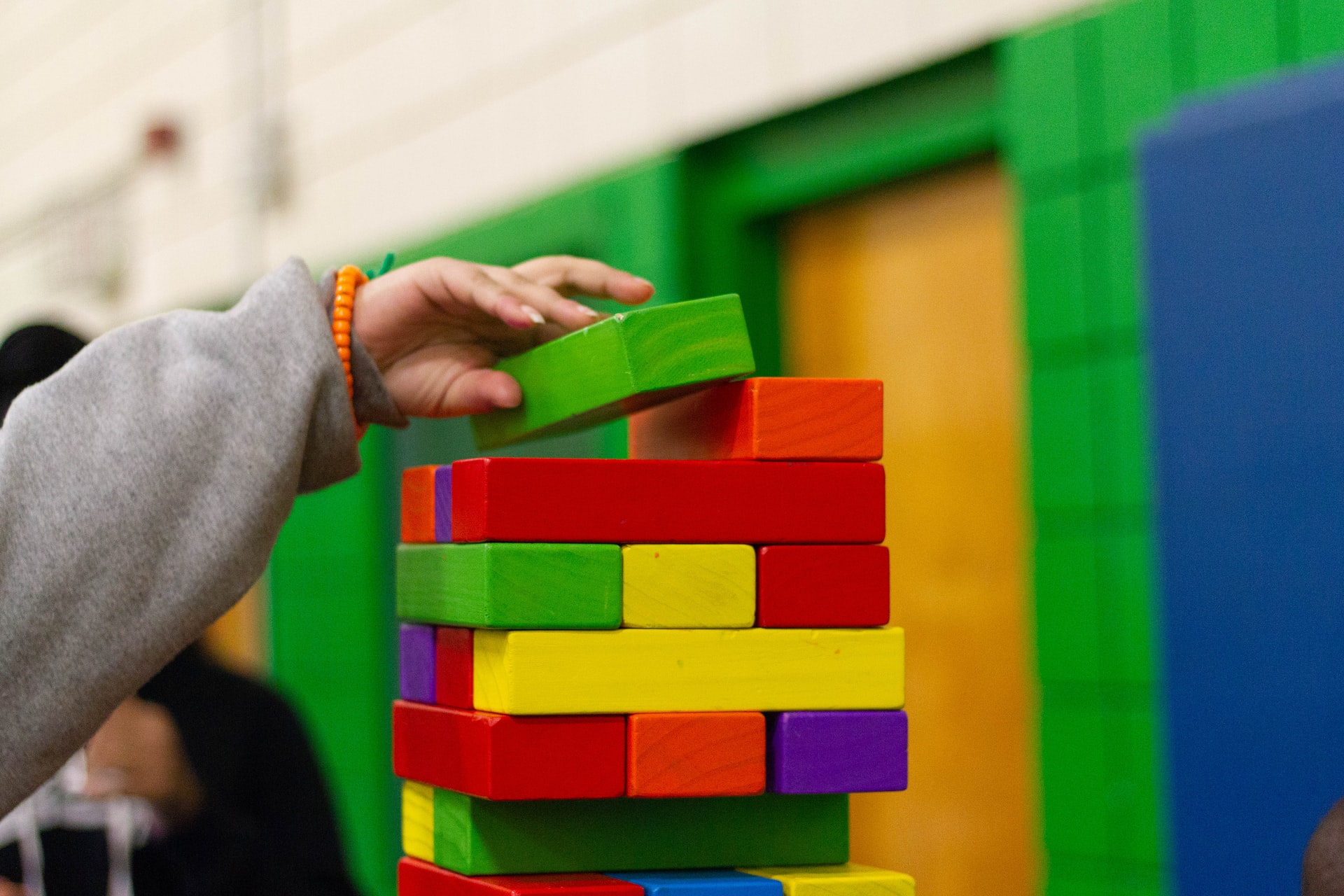Incremental Delivery showing a child's hand stacking colorful blocks